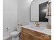 Stylish bathroom features a wood vanity, white countertop, gold faucet, and decorative patterned tile flooring at 18027 Wilbanks Dr, Charlotte, NC 28278