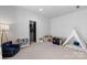 Playful bedroom with a cute teepee, comfortable chair, and a fun bookcase at 18027 Wilbanks Dr, Charlotte, NC 28278