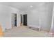 Simple bedroom with white carpet, walls, and a crib in the corner at 18027 Wilbanks Dr, Charlotte, NC 28278