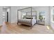 Well-lit bedroom with a four-poster bed, hardwood floors, and coordinating bedside tables at 18027 Wilbanks Dr, Charlotte, NC 28278