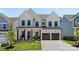 Charming two-story home showcasing a well-manicured lawn, a covered porch, and a two-car garage at 18027 Wilbanks Dr, Charlotte, NC 28278
