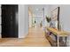 Open concept foyer with hardwood floors, stylish console table, and view of living room and dining area at 18027 Wilbanks Dr, Charlotte, NC 28278