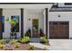Inviting front entry with craftsman style front door, stylish planters and walkway, and a two car garage at 18027 Wilbanks Dr, Charlotte, NC 28278