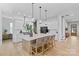 Modern kitchen with island bar, white cabinets, stainless appliances, and hardwood floors at 18027 Wilbanks Dr, Charlotte, NC 28278