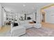 Open-concept living room featuring a spacious white sofa and seamless transition to the dining area at 18027 Wilbanks Dr, Charlotte, NC 28278