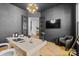 Spacious office with built-in shelving, stylish decor, and large screen television at 18027 Wilbanks Dr, Charlotte, NC 28278