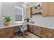 Bright office with custom cabinets, a built-in desk, and stylish decor that accentuates the interior design at 18027 Wilbanks Dr, Charlotte, NC 28278