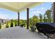 Spacious covered patio with a grill, flowers, and outdoor seating, perfect for entertaining at 18027 Wilbanks Dr, Charlotte, NC 28278