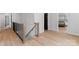 Modern staircase with wood flooring, black railing, and natural light at 18027 Wilbanks Dr, Charlotte, NC 28278