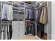 Organized walk-in closet with built-in shelving, drawers, and ample hanging space at 18027 Wilbanks Dr, Charlotte, NC 28278