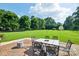 Lush backyard with a brick patio and outdoor dining set at 181 Brook Glen Dr # 56, Mooresville, NC 28115