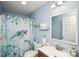 Charming bathroom featuring blue walls, patterned shower curtain, and modern fixtures at 181 Brook Glen Dr # 56, Mooresville, NC 28115