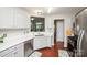 Bright kitchen features white cabinets, stainless steel appliances, and a view to the living area, perfect for entertaining at 181 Brook Glen Dr # 56, Mooresville, NC 28115