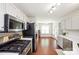 Functional kitchen boasting stainless steel appliances, white cabinets, and hardwood floors, seamlessly connecting to the breakfast nook at 181 Brook Glen Dr # 56, Mooresville, NC 28115