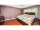Comfortable main bedroom features hardwood floors, natural light, and a calm aesthetic for rest and relaxation at 181 Brook Glen Dr # 56, Mooresville, NC 28115