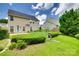 Well-maintained backyard featuring lush green grass, manicured hedges, and a serene setting, creating an outdoor haven at 1930 Caprington Dr, Fort Mill, SC 29707