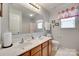 Well-lit bathroom featuring a double sink vanity, large mirror, and decorative accents providing a clean and functional space at 1930 Caprington Dr, Fort Mill, SC 29707