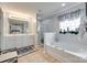 Bright bathroom features a soaking tub, separate shower and large window, perfect for relaxation and natural light at 1930 Caprington Dr, Fort Mill, SC 29707