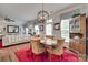 Well-lit dining area with a hardwood table and cozy seating, perfect for Gathering meals and entertaining guests at 1930 Caprington Dr, Fort Mill, SC 29707