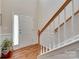 Bright foyer with hardwood floors and a staircase that offers a view of the front door and a hint of natural light at 1930 Caprington Dr, Fort Mill, SC 29707