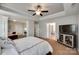 Spacious primary bedroom boasts a tray ceiling, ensuite bathroom and a relaxing seating area, perfect for unwinding at 1930 Caprington Dr, Fort Mill, SC 29707
