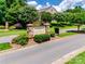 Community entrance featuring stone signage, lush landscaping, and well-maintained street, presenting an inviting welcome at 1930 Caprington Dr, Fort Mill, SC 29707