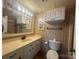 Well-lit bathroom with vanity, mirror, and toilet at 195 Keats Rd, Mooresville, NC 28117