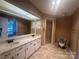 Neutral-toned bathroom with double vanity, large mirror, and walk-in shower at 195 Keats Rd, Mooresville, NC 28117