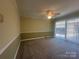 Bedroom with wall-to-wall carpet and sliding glass doors to backyard at 195 Keats Rd, Mooresville, NC 28117