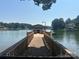 Private wooden dock with a covered boat slip, offering direct access to the tranquil lake at 195 Keats Rd, Mooresville, NC 28117