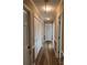 Hallway with wood-look flooring, wainscoting, and multiple closets at 195 Keats Rd, Mooresville, NC 28117