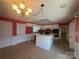 Bright kitchen featuring white cabinets and an island with cooktop at 195 Keats Rd, Mooresville, NC 28117