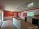 Bright kitchen featuring white cabinets and an island with cooktop at 195 Keats Rd, Mooresville, NC 28117