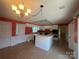 Bright kitchen featuring white cabinets and an island with cooktop at 195 Keats Rd, Mooresville, NC 28117