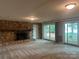 Living room with stone fireplace and sliding glass doors leading to the backyard at 195 Keats Rd, Mooresville, NC 28117