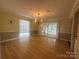 Open concept living room with hardwood floors and chandelier at 195 Keats Rd, Mooresville, NC 28117