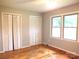 Sunlit bedroom featuring hardwood floors, large windows, and closet space at 2116 Upson Dr, Lancaster, SC 29720