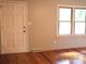 Cozy entryway with natural light, hardwood floors, and a white front door at 2116 Upson Dr, Lancaster, SC 29720