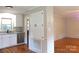 Open kitchen with stainless steel appliances and hardwood floors adjacent to another room at 2116 Upson Dr, Lancaster, SC 29720