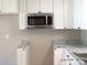 Modern kitchen featuring granite countertops and a stainless steel microwave at 2116 Upson Dr, Lancaster, SC 29720
