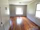 Bright living room with hardwood floors, white trim, and lots of natural light at 2116 Upson Dr, Lancaster, SC 29720