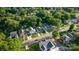 An aerial view shows homes with well-maintained lawns and mature trees in a neighborhood setting at 215 Cedar St, Belmont, NC 28012