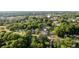 Aerial view showcasing a neighborhood surrounded by lush greenery and mature trees at 215 Cedar St, Belmont, NC 28012