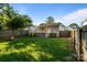 Spacious backyard with lush green grass, a fire pit, and a deck, perfect for relaxation and outdoor activities at 215 Cedar St, Belmont, NC 28012