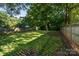 The large backyard with mature trees offers a spacious area for outdoor activities and a serene escape at 215 Cedar St, Belmont, NC 28012