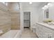 Bathroom with tile floors, decorative tile shower, and updated vanity at 215 Cedar St, Belmont, NC 28012