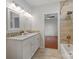Bathroom showing double vanity, decorative tile, and entrance to closet at 215 Cedar St, Belmont, NC 28012