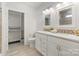 Bright bathroom features a double vanity with quartz countertops and two mirrors at 215 Cedar St, Belmont, NC 28012