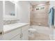 Bright bathroom features a shower-tub combination with decorative tiling and modern fixtures at 215 Cedar St, Belmont, NC 28012