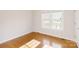 Well-lit bedroom with hardwood floors, double windows, and neutral paint for a cozy atmosphere at 215 Cedar St, Belmont, NC 28012
